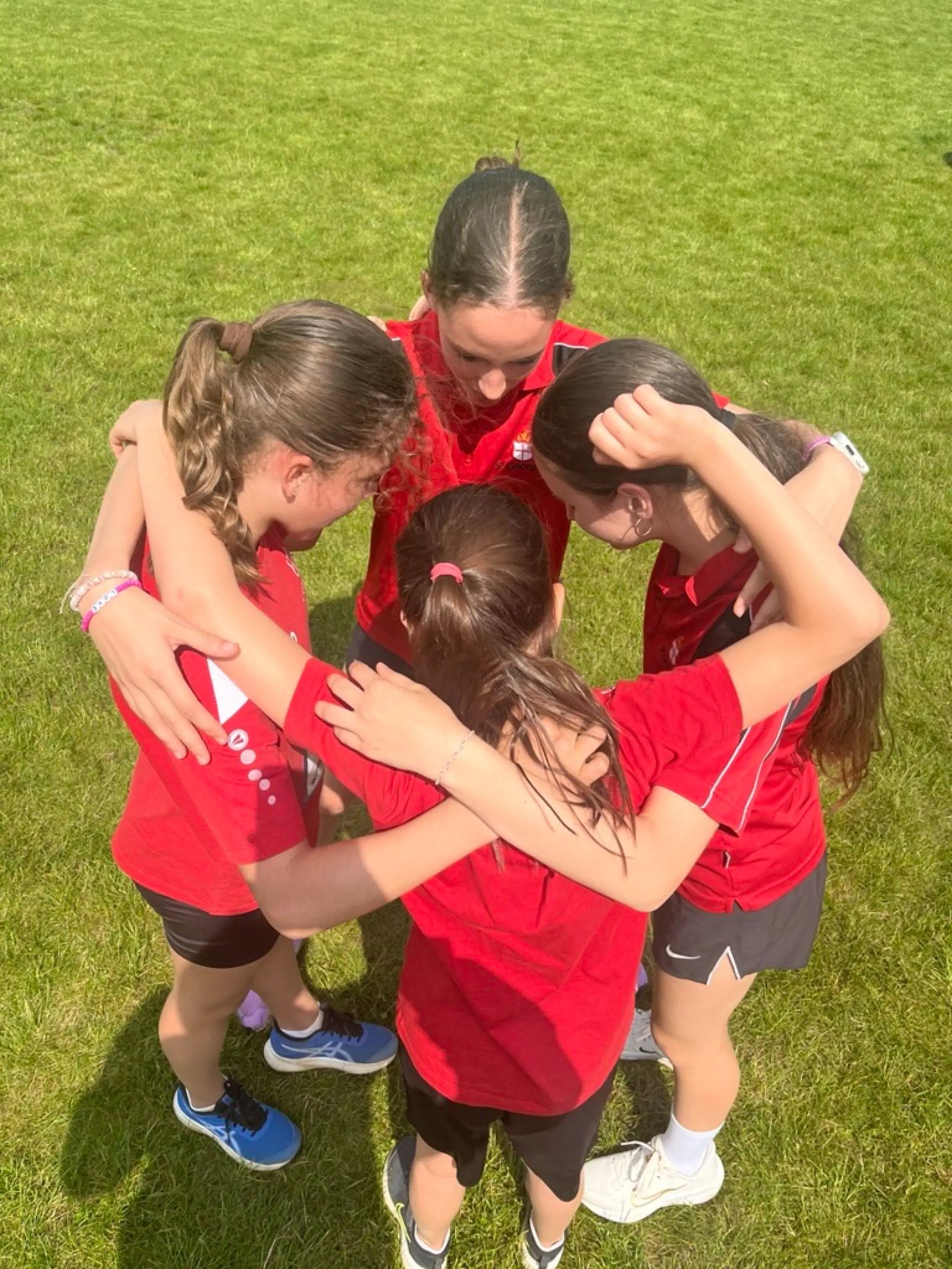 Female sports team huddle
