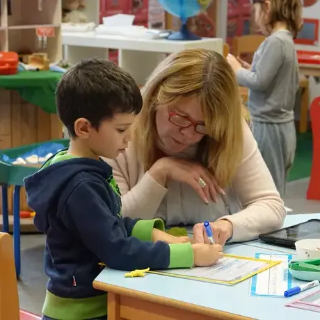 Teacher helping young child