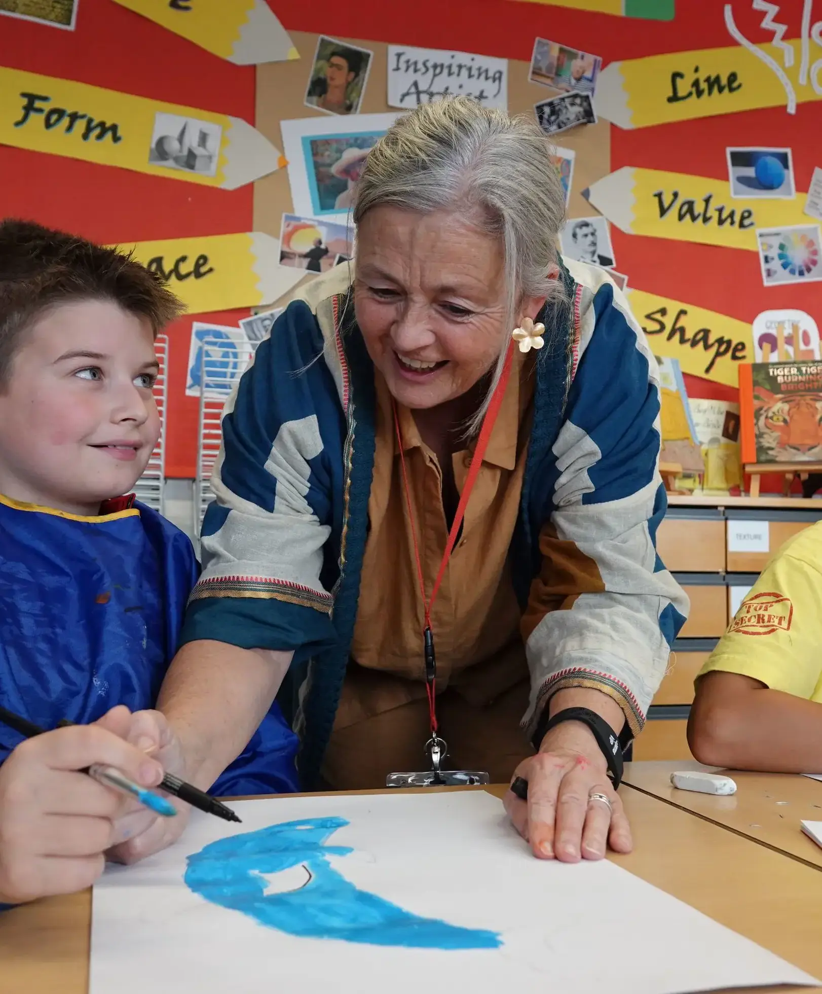 Art teacher helping student