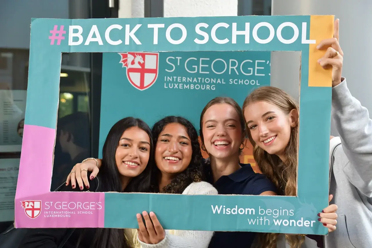 Older female students holding frame