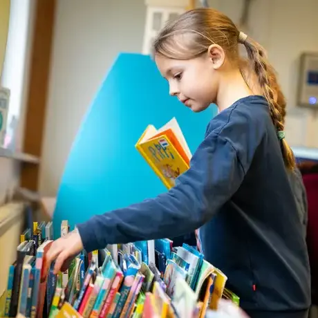 Child looking through books